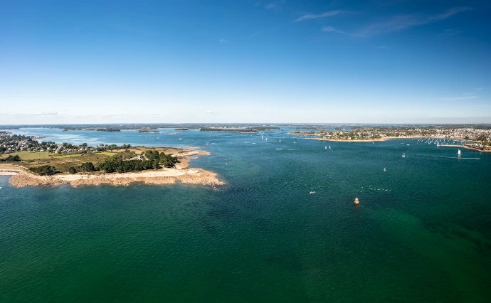 a body of water with a small island in the middle of it